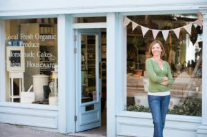 woman standing in front of her small business store